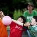 Liam Coolican, Joe Bachman, and Mateo Wakeman reach for a ball on Friday, June 21. Daniel Brenner I AnnArbor.com